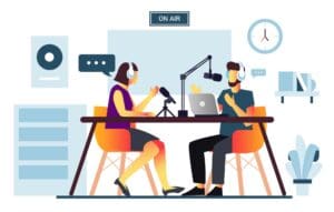 An illustration of two people recording a podcast in a studio. They sit across a table with microphones, headphones, and a laptop labeled "CodersLink Tips," engaged in conversation about empleo en TI. A sign above them reads "ON AIR." The background features a clock and shelves with decor. CodersLink 2024.