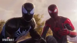 Two Spider-Men crouch side by side in this "Spider-Man 2" image. On the left is Spider-Man in a black suit with a white spider emblem, reminiscent of software developers for hire. On the right is Spider-Man wearing a black and red suit with a red spider emblem. The background shows trees and a clear sky. CodersLink 2024.