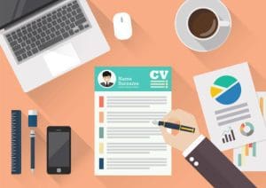 Illustration of a person reviewing a colorful CV de programador at a desk. The desk also has a laptop, mouse, smartphone, coffee cup, ruler, and various charts. The Curriculum Vitae features a photo, name, and various sections highlighted in different colors. CodersLink 2024.