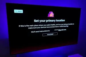A TV screen displaying a Netflix prompt to set a primary location. The message reads: "Set your primary location. If this is the main place where you watch Netflix, set it as your primary location to ensure seamless access whether you're home or traveling. CodersLink 2024.